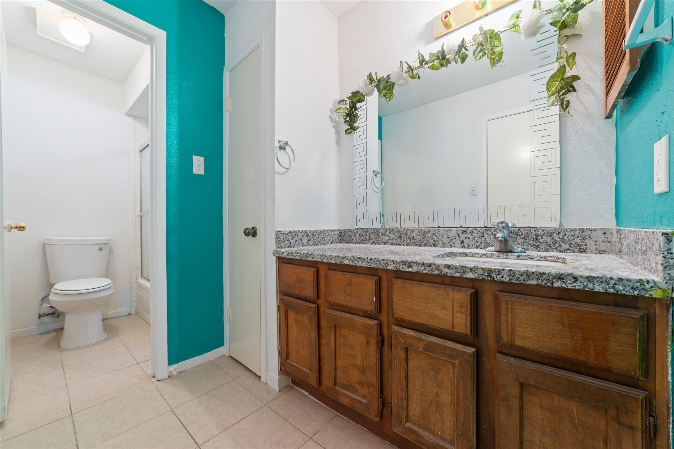 4222 Amir Street Houston, TX 77072 - Photo 10 of 21 a bathroom with a granite countertop sink and a toilet