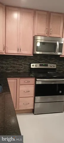 a stove top oven sitting inside of a kitchen