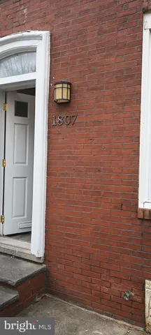 an empty room with wooden floor & closet area