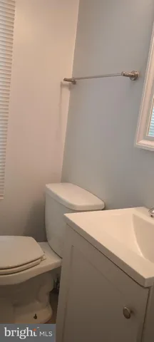 a white toilet sitting next to a white sink