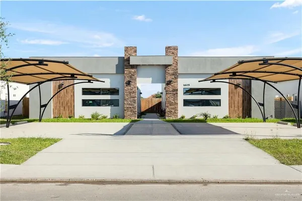 a front view of a house with a yard and table