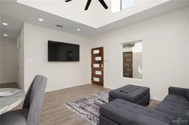 a living room with couches and a flat screen tv