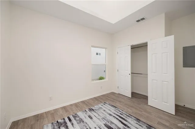 a view of a room with wooden floor and white doors