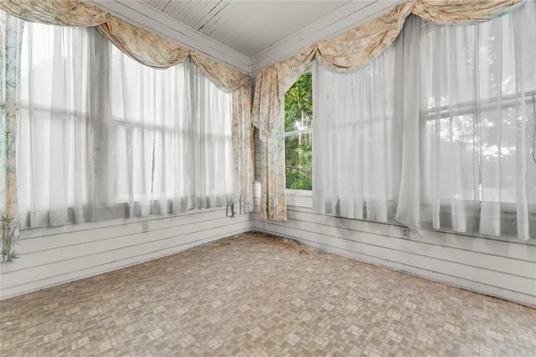 a view of wooden floor and windows in a room