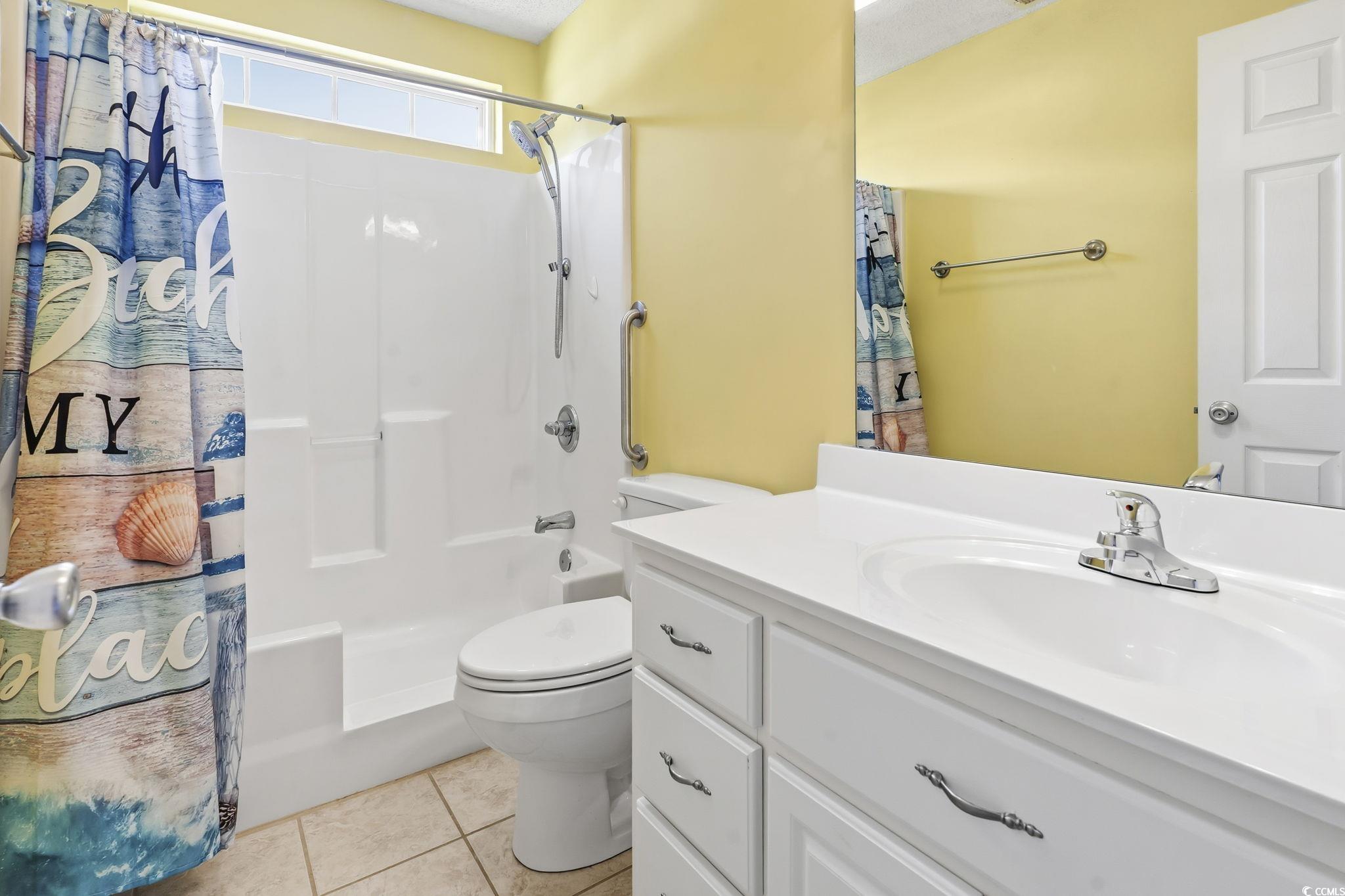 1007 Green Fir Loop Conway, SC 29527 - Photo 20 of 38 Full bath with light tile patterned floors, vanity, and shower / tub combo with curtain