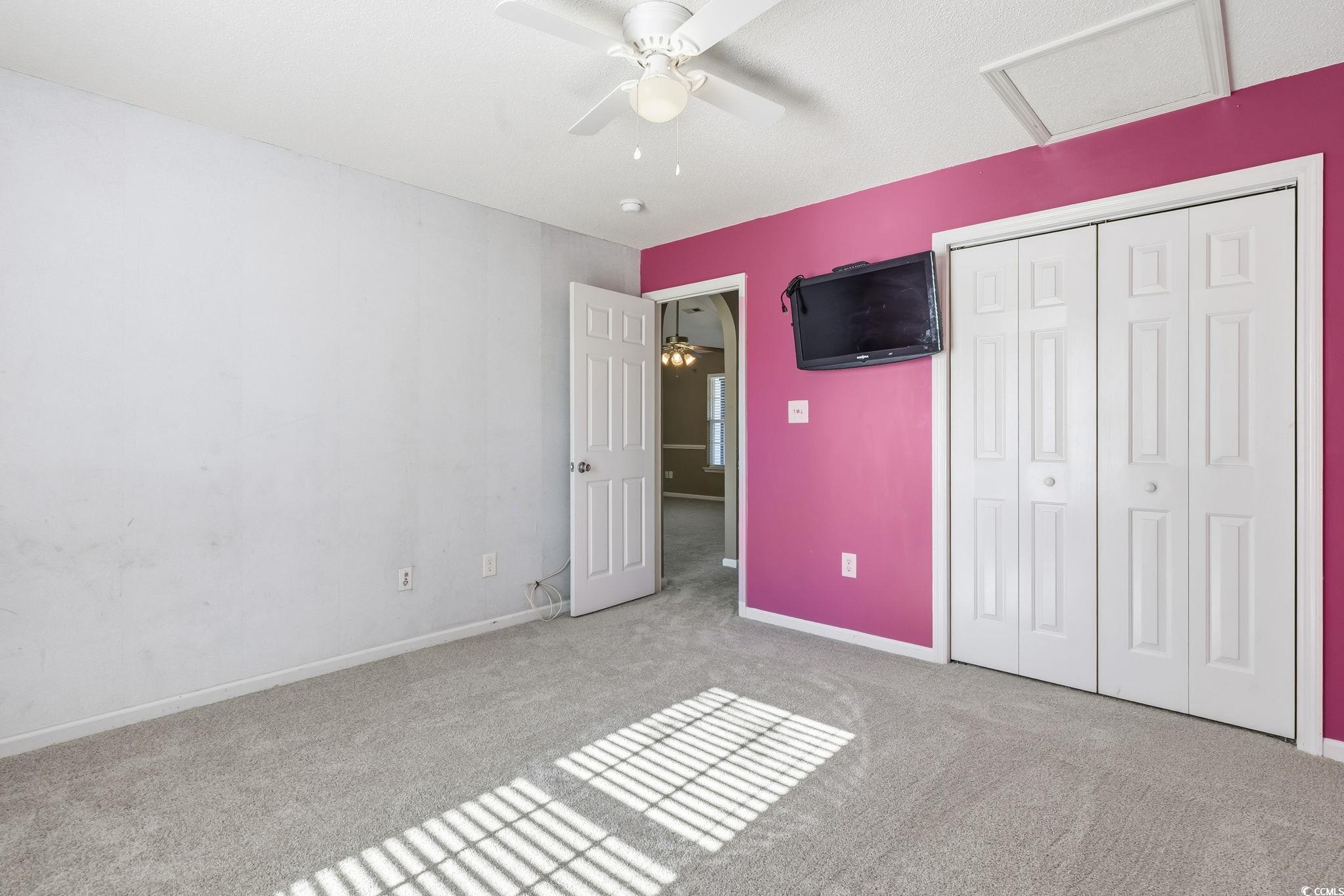 1007 Green Fir Loop Conway, SC 29527 - Photo 21 of 38 Unfurnished bedroom with carpet floors, attic access, a ceiling fan, and a closet