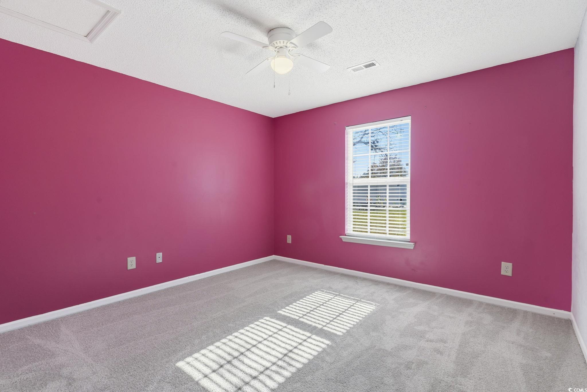 1007 Green Fir Loop Conway, SC 29527 - Photo 22 of 38 Carpeted spare room featuring ceiling fan, a textured ceiling, and attic access