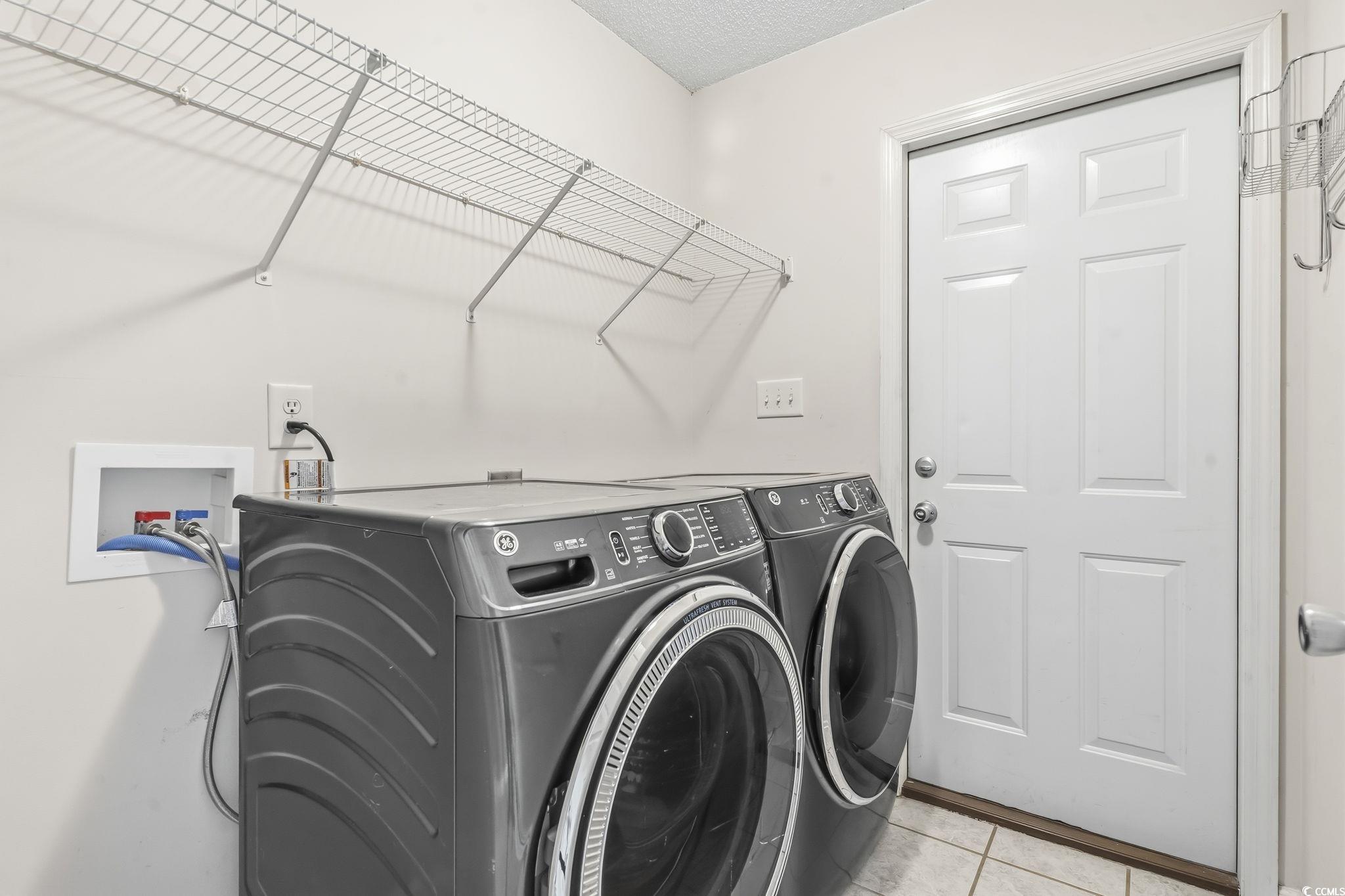 1007 Green Fir Loop Conway, SC 29527 - Photo 23 of 38 Washroom with light tile patterned flooring, separate washer and dryer, and a textured ceiling