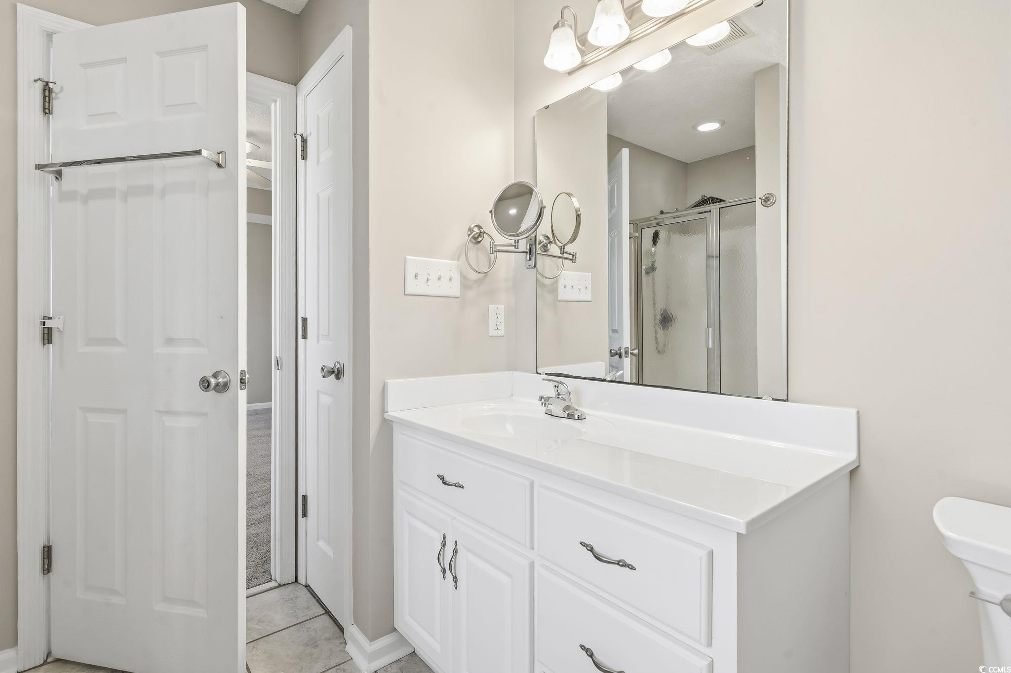 1007 Green Fir Loop Conway, SC 29527 - Photo 27 of 38 Bathroom featuring a stall shower, vanity, and light tile patterned floors