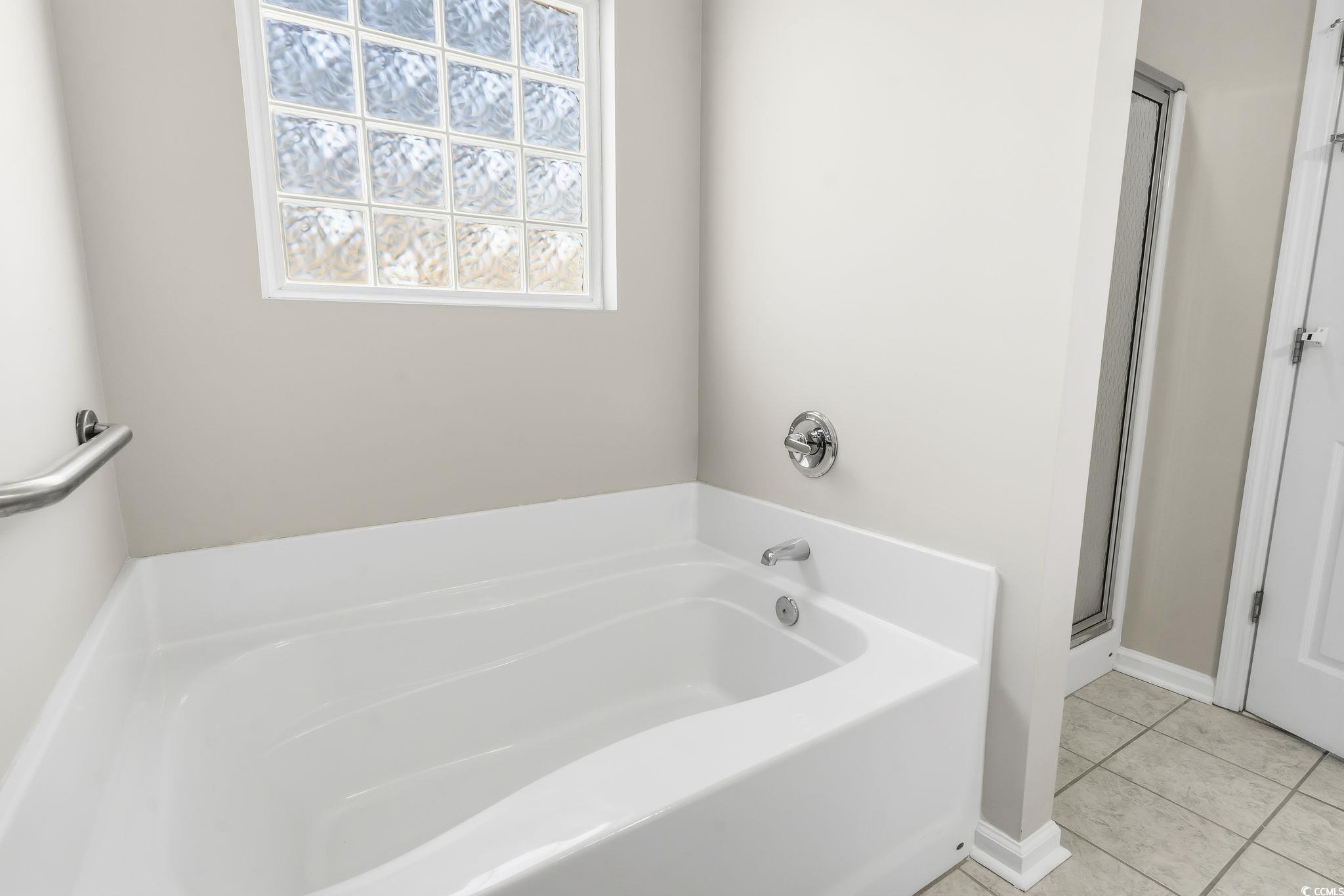1007 Green Fir Loop Conway, SC 29527 - Photo 28 of 38 Bathroom featuring a garden tub, light tile patterned floors, and a shower stall