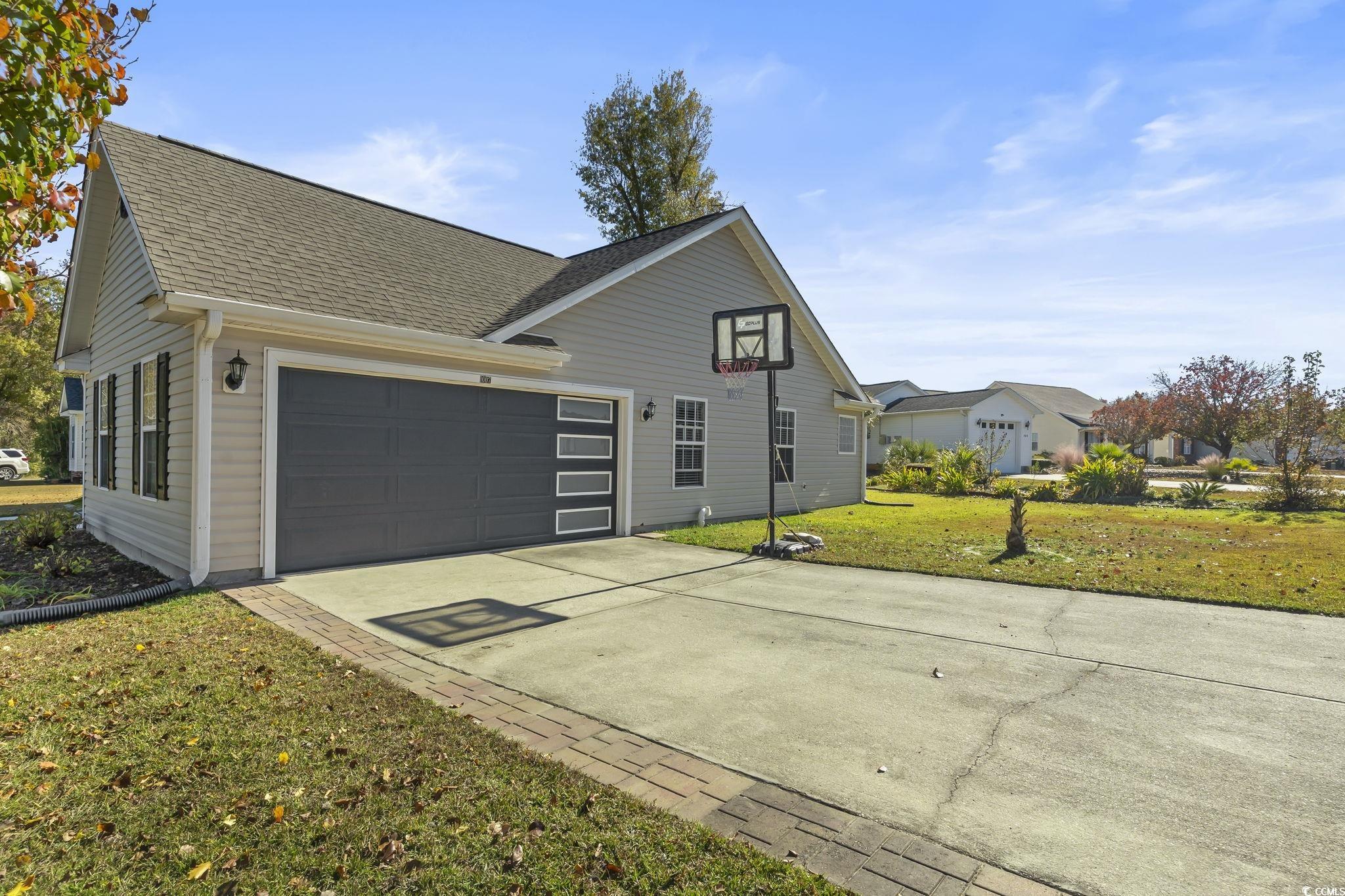 1007 Green Fir Loop Conway, SC 29527 - Photo 3 of 38 View of front of property with a front yard, driveway, roof with shingles, and a garage