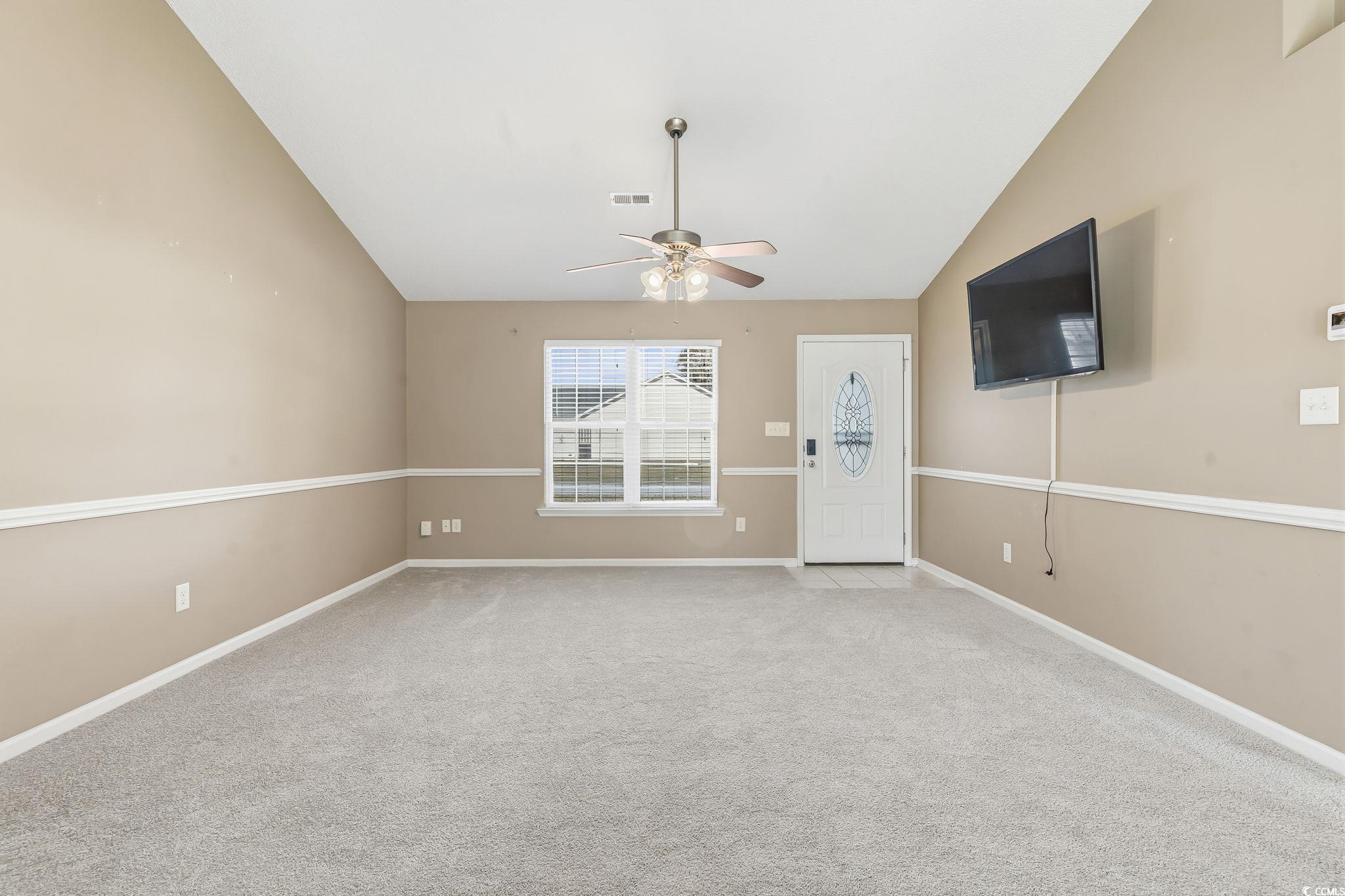 1007 Green Fir Loop Conway, SC 29527 - Photo 7 of 38 Unfurnished living room with carpet floors, vaulted ceiling, and a ceiling fan