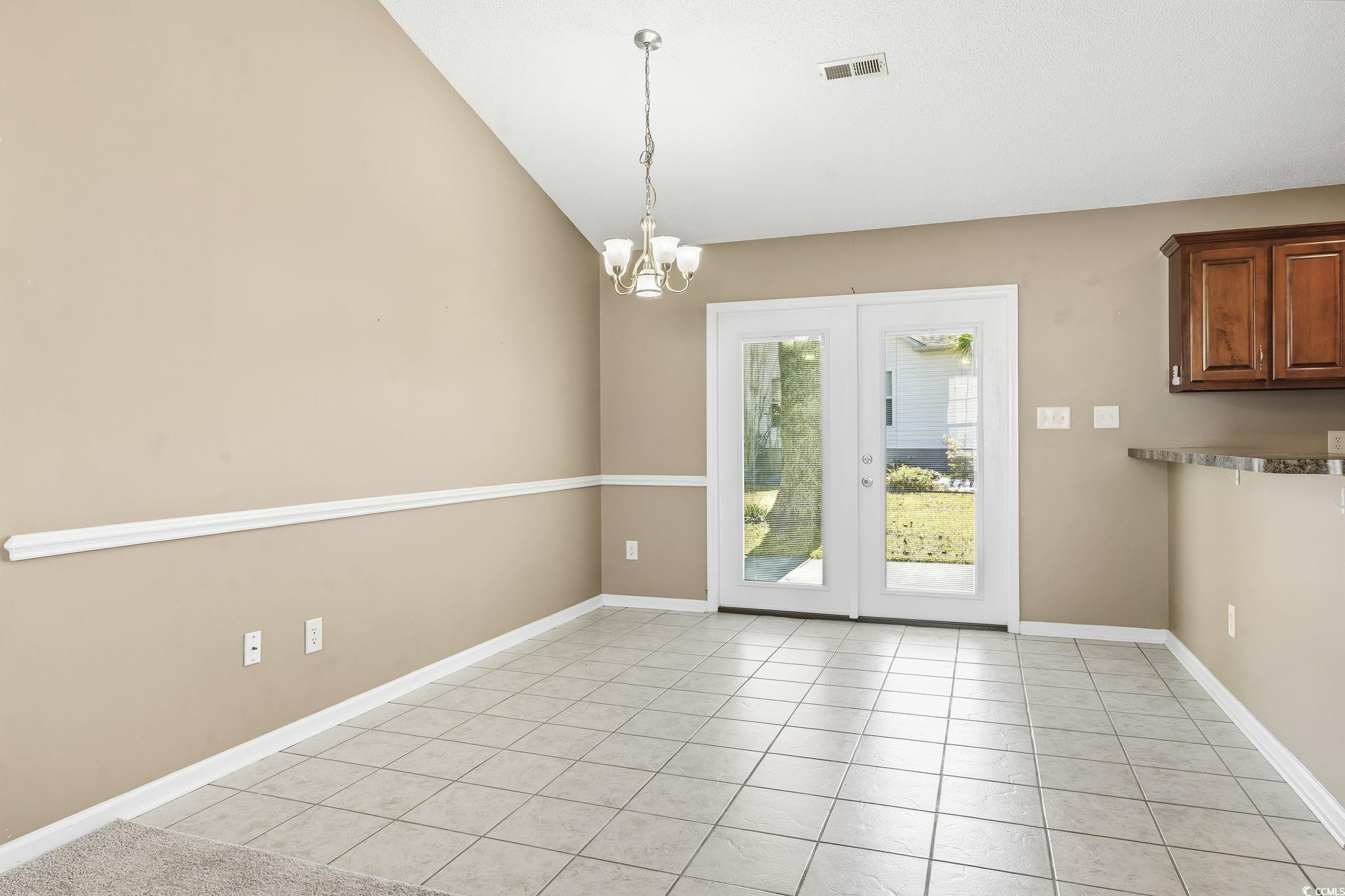 1007 Green Fir Loop Conway, SC 29527 - Photo 8 of 38 Unfurnished dining area with light tile patterned flooring, a chandelier, and lofted ceiling