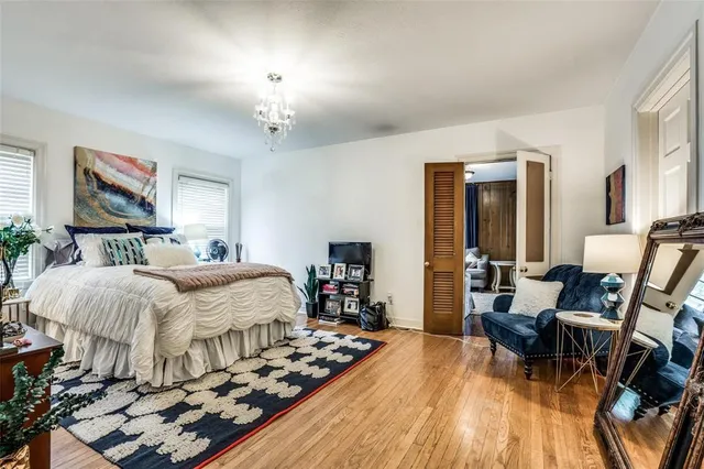 a bedroom with bed and wooden floor