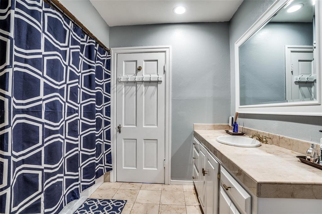 5910 McCommas Boulevard Dallas, TX 75206 - Photo 14 of 22 a bathroom with a sink and a mirror