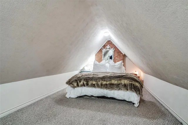 a spacious bedroom with a bed and a window