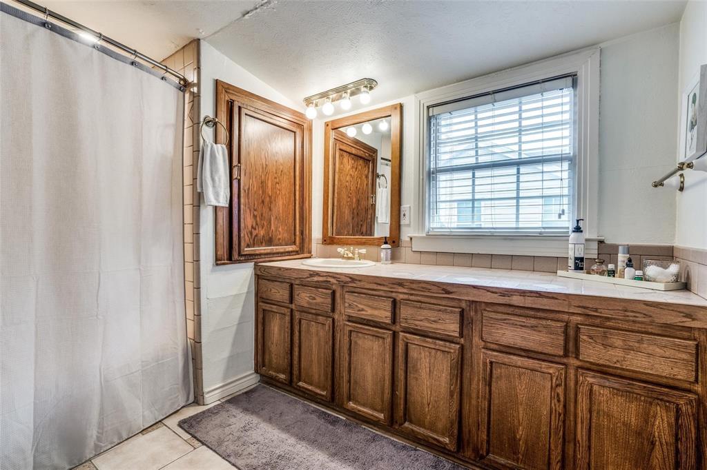 5910 McCommas Boulevard Dallas, TX 75206 - Photo 16 of 22 a bathroom with double vanity and a mirror