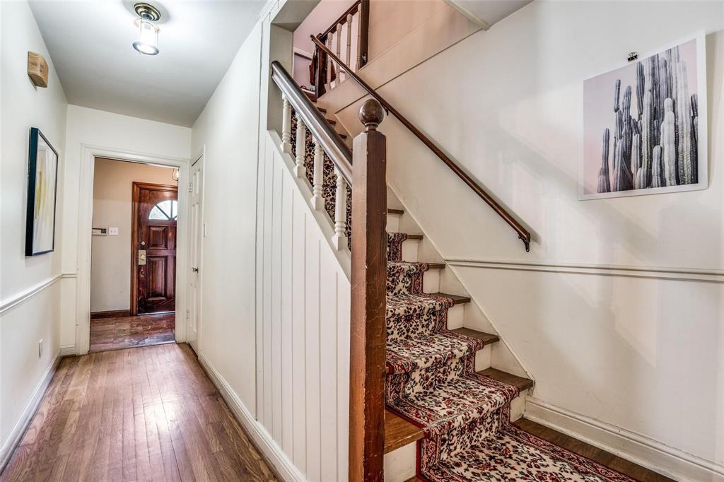 5910 McCommas Boulevard Dallas, TX 75206 - Photo 5 of 22 a view of a hallway with wooden floor and stairs
