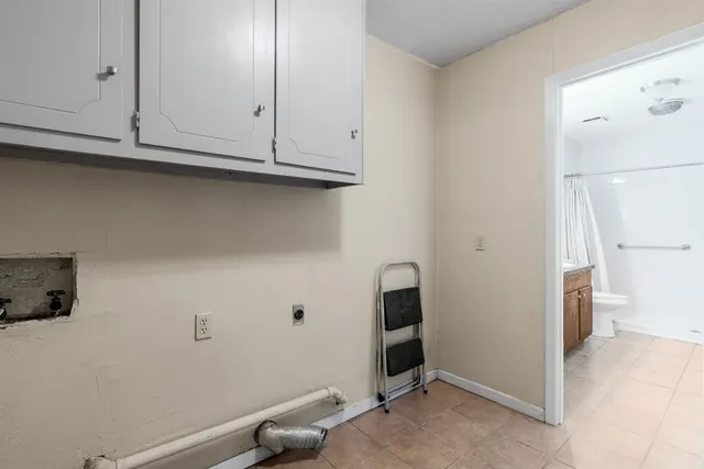 a kitchen with granite countertop white cabinets and stainless steel appliances