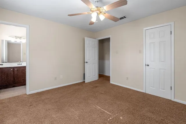 a bathroom with a sink a toilet a mirror and shower curtain