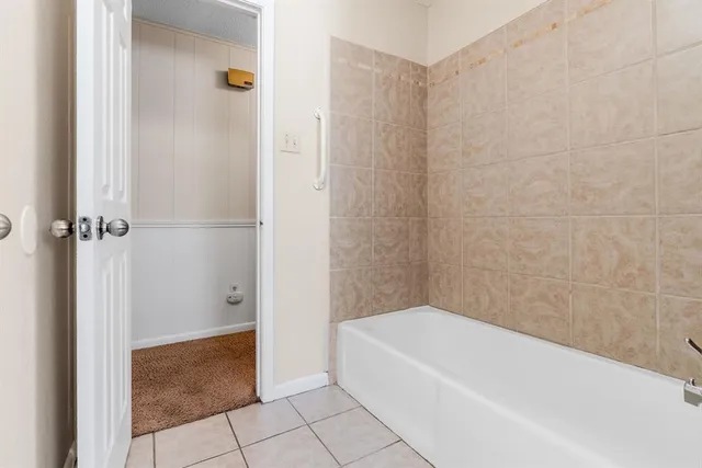 a bathroom with a bathtub and shower