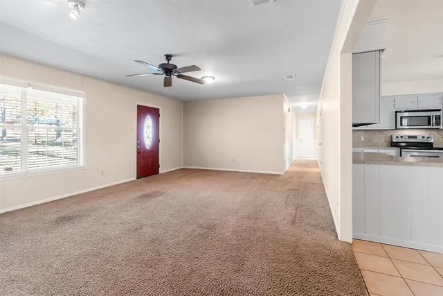 a view of a kitchen with a sink and a refrigerator