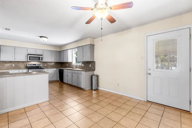 a kitchen with stainless steel appliances granite countertop a refrigerator sink and cabinets