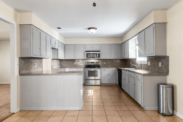 a kitchen with cabinets and window