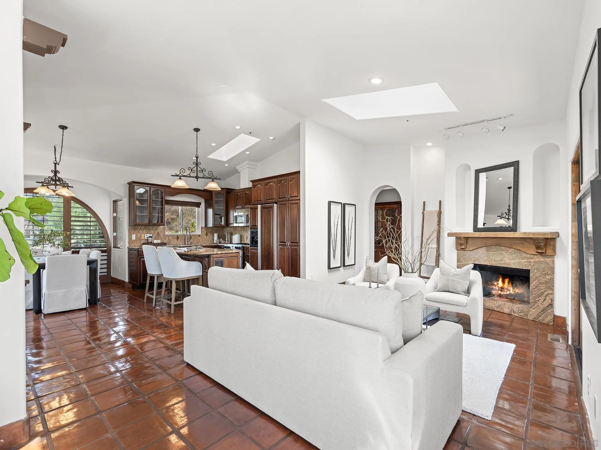 3485 Lone Jack Road Encinitas, CA 92024 - Photo 3 of 27 a living room with furniture a fireplace and a chandelier