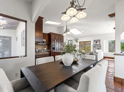 a view of a dining room and kitchen with a table chairs and chandelier