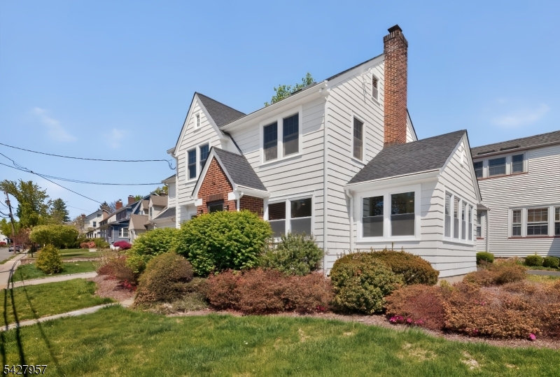 909 Ridgewood Road Millburn, NJ 07041 - Photo 25 of 33 a front view of house with yard and green space