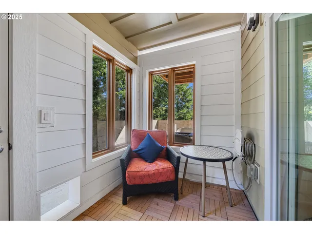 a outdoor space with a couch and wooden floor