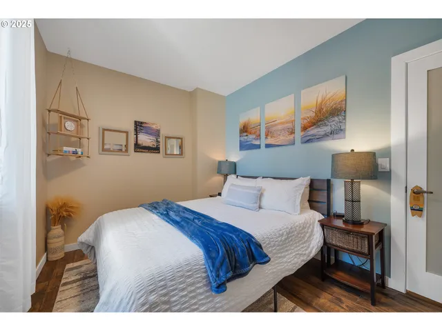 a bedroom with a bed a lamp and a large mirror