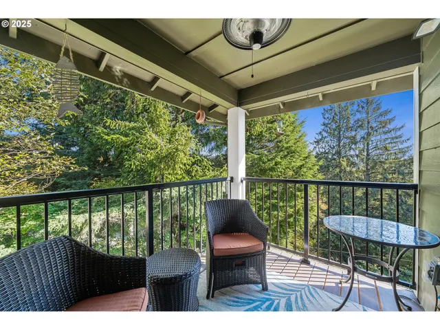 a view of a chairs and table in the balcony