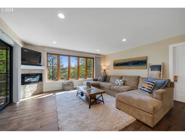 a living room with furniture window and a fireplace