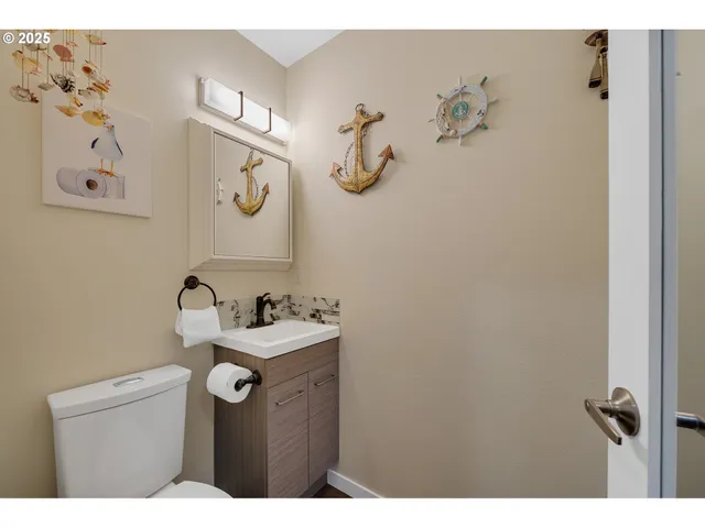 a bathroom with a sink mirror and vanity