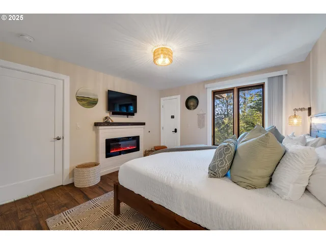 a bedroom with a bed and a flat screen tv