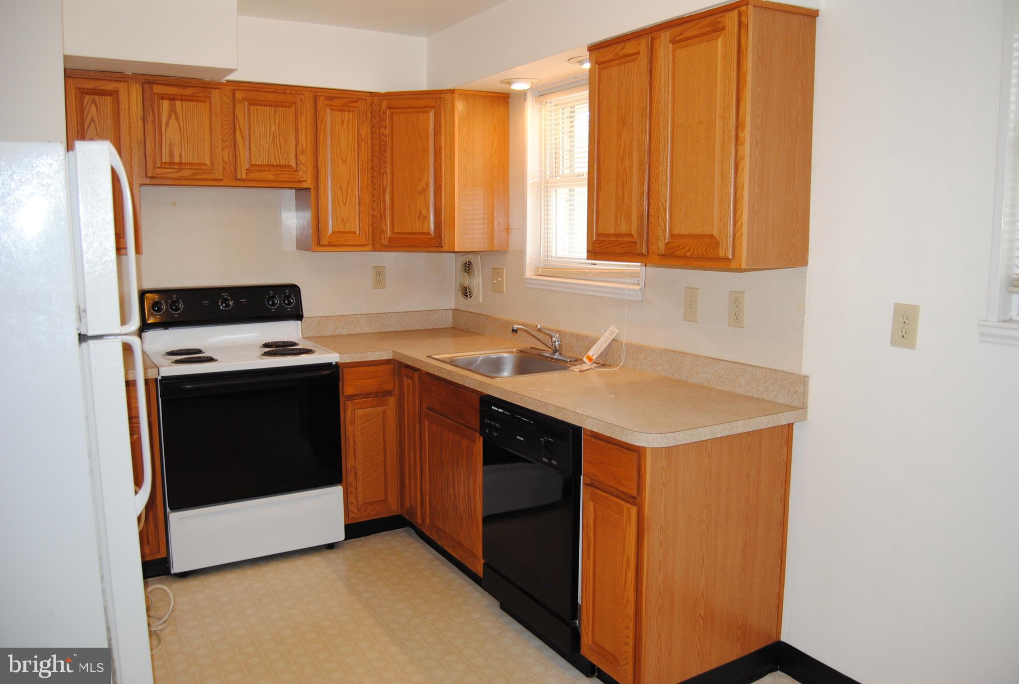 502 Norma Lane Norristown, PA 19401 - Photo 11 of 24 a kitchen with a sink stove and cabinets