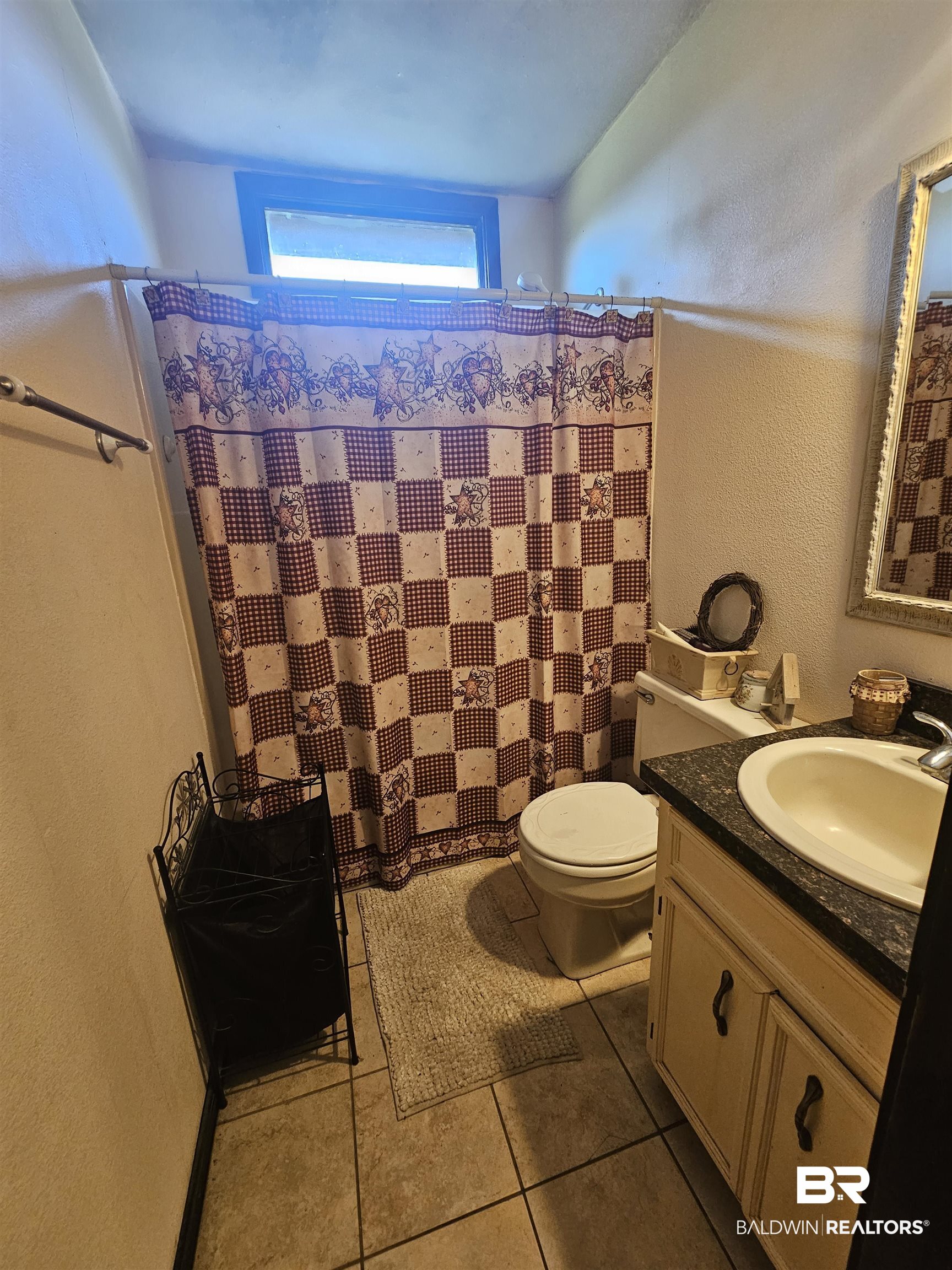 1818 Old Fannie Road Flomaton, AL 36441 - Photo 18 of 20 Bathroom with vanity, tile patterned floors, and a textured wall