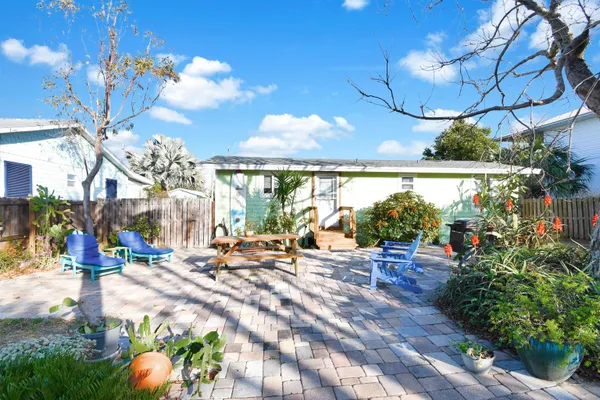 a kitchen with stainless steel appliances granite countertop a stove top oven a sink dishwasher and white cabinets with wooden floor