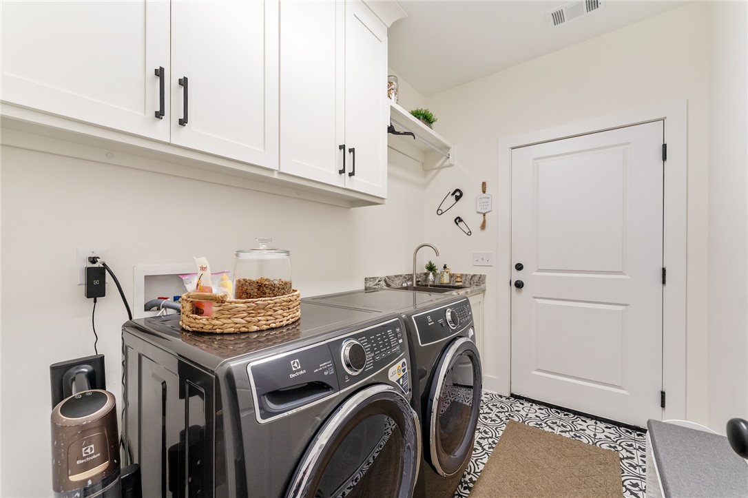 502 Canebrake Drive Anderson, SC 29621 - Photo 27 of 39 This functional laundry room features convenient upper cabinetry and a sink, making chores effortless.
