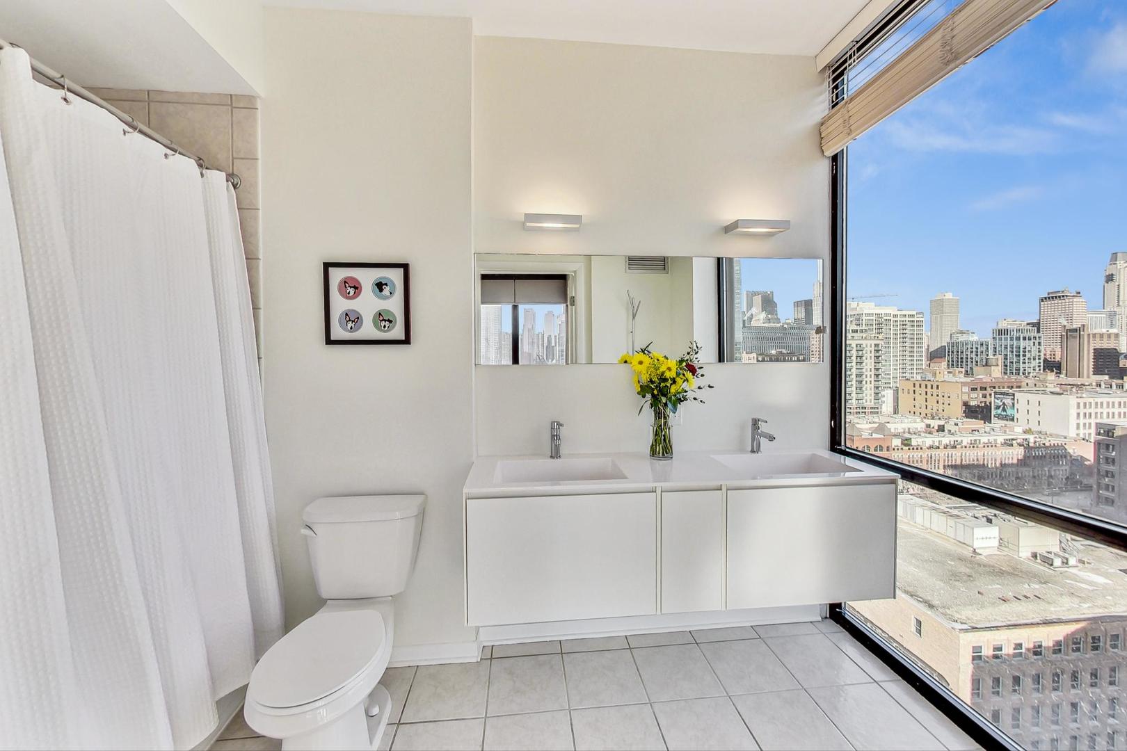 435 West Erie Street, Unit 1501 Chicago, IL 60654 - Photo 14 of 26 a bathroom with a sink a toilet and mirror