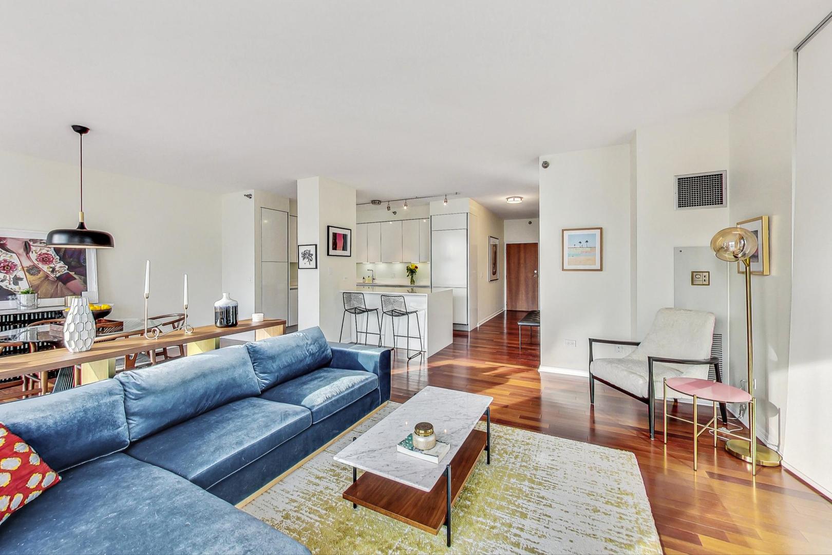 435 West Erie Street, Unit 1501 Chicago, IL 60654 - Photo 6 of 26 a living room with furniture a rug and a table