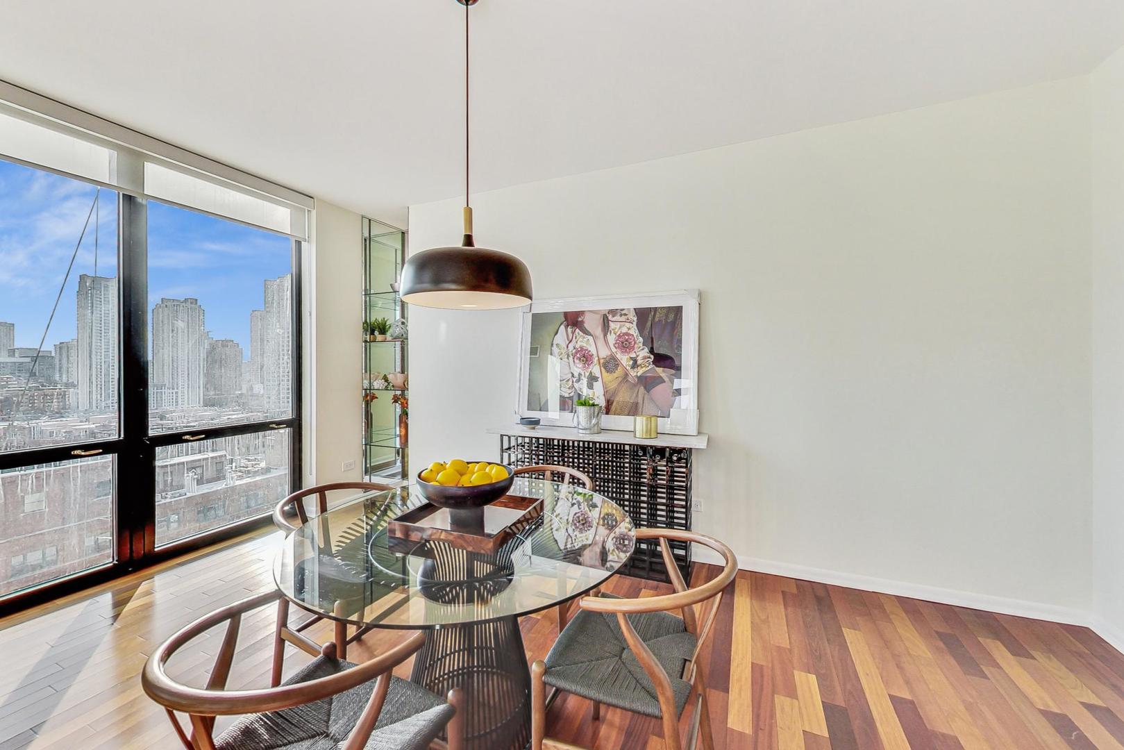 435 West Erie Street, Unit 1501 Chicago, IL 60654 - Photo 7 of 26 a view of a dining room with furniture and wooden floor