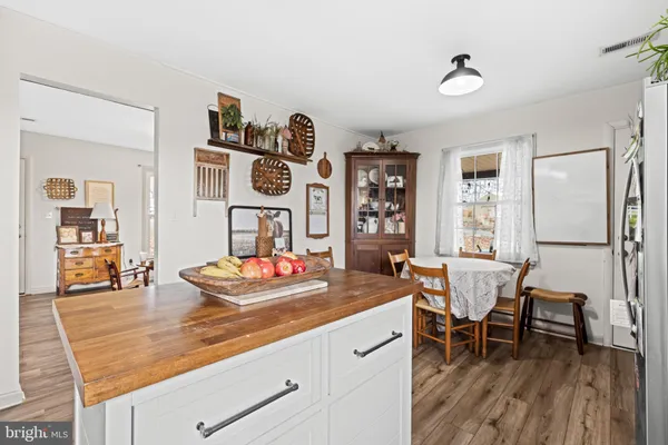 a dining room with furniture and wooden floor