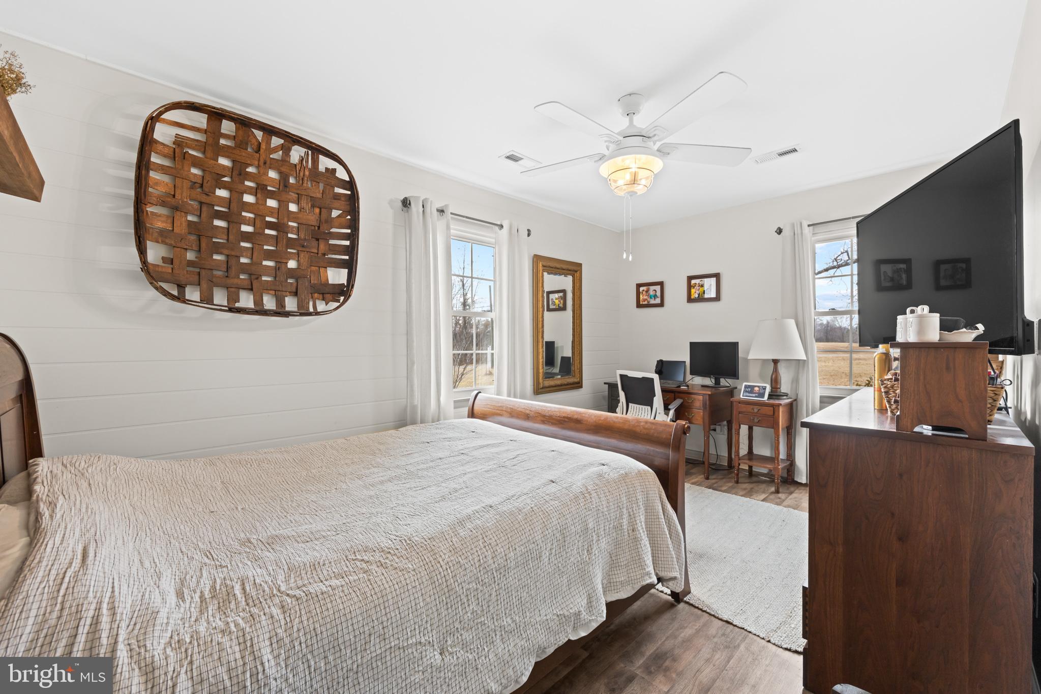 84 Clore Road Madison, VA 22727 - Photo 16 of 28 a bedroom with a large bed and a chandelier