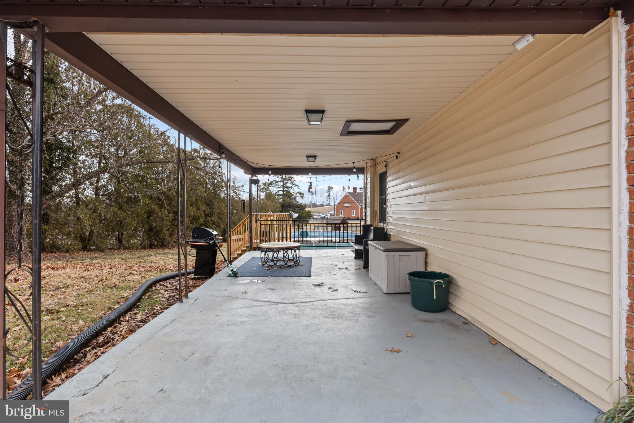 84 Clore Road Madison, VA 22727 - Photo 19 of 28 a view of a patio with table and chairs and potted plants