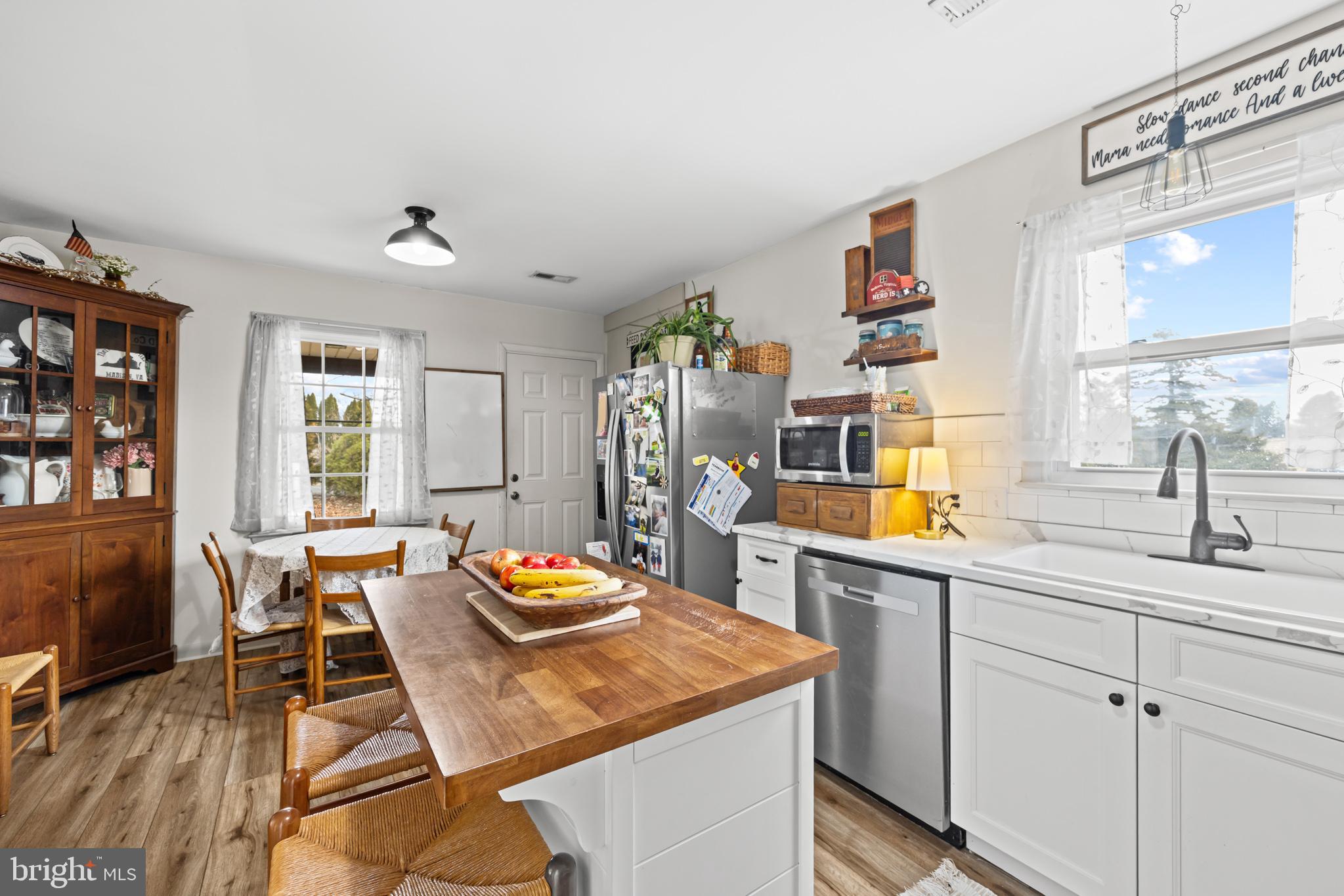 84 Clore Road Madison, VA 22727 - Photo 9 of 28 a open kitchen with stainless steel appliances granite countertop a sink dishwasher and cabinets with wooden floor