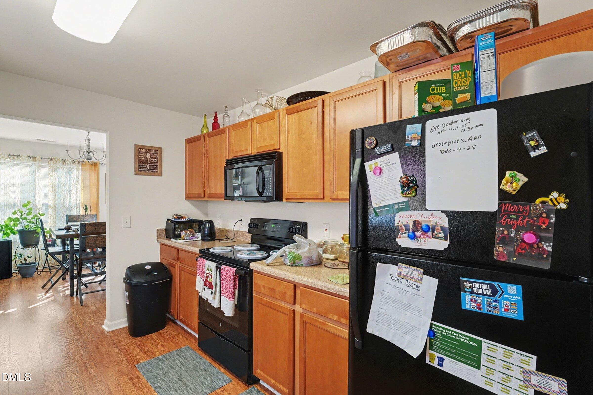 1404 Ricochet Drive Raleigh, NC 27610 - Photo 11 of 31 a kitchen with stainless steel appliances granite countertop a refrigerator and a stove top oven