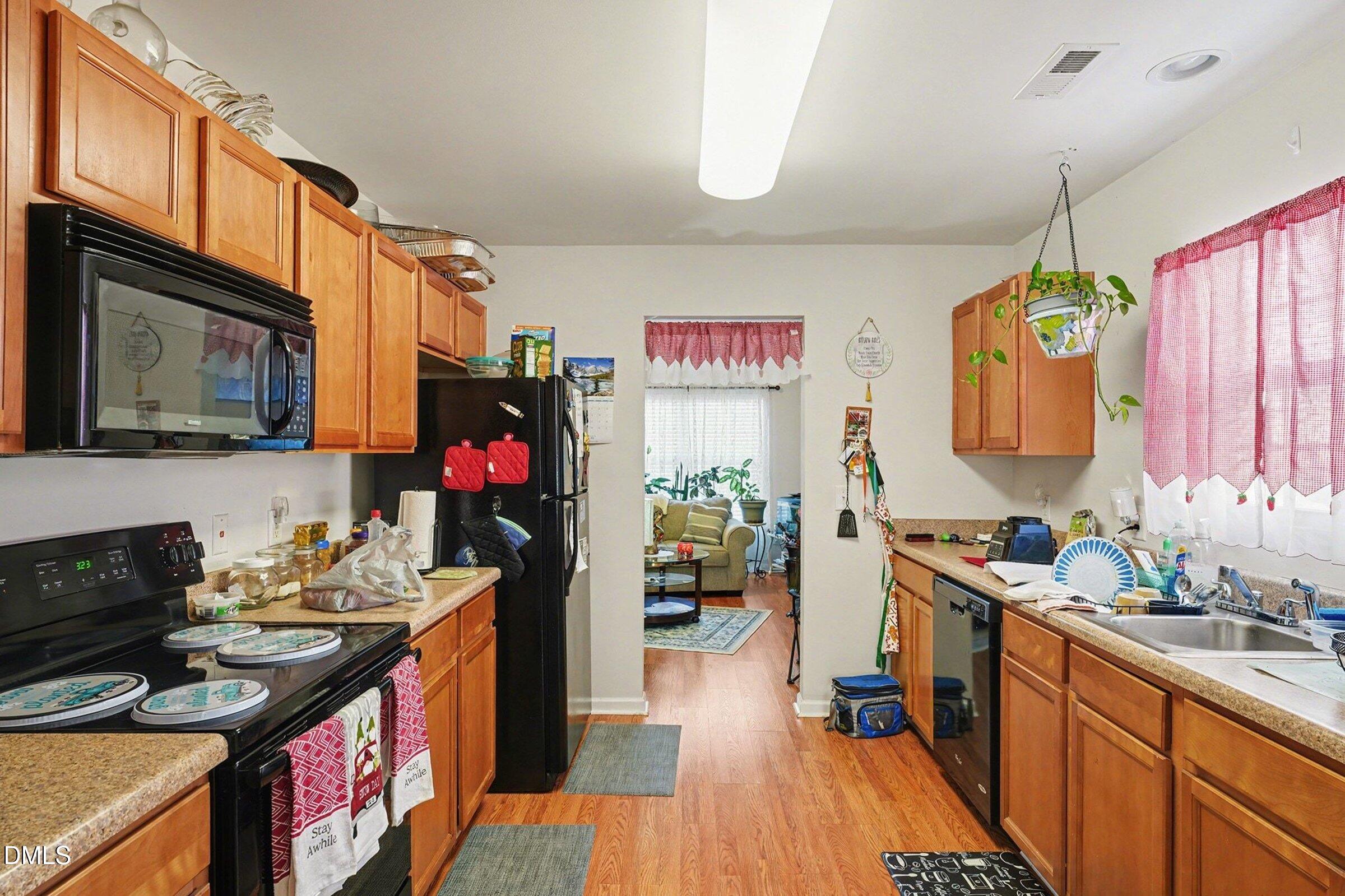 1404 Ricochet Drive Raleigh, NC 27610 - Photo 13 of 31 a kitchen filled a counter space a sink and a stove